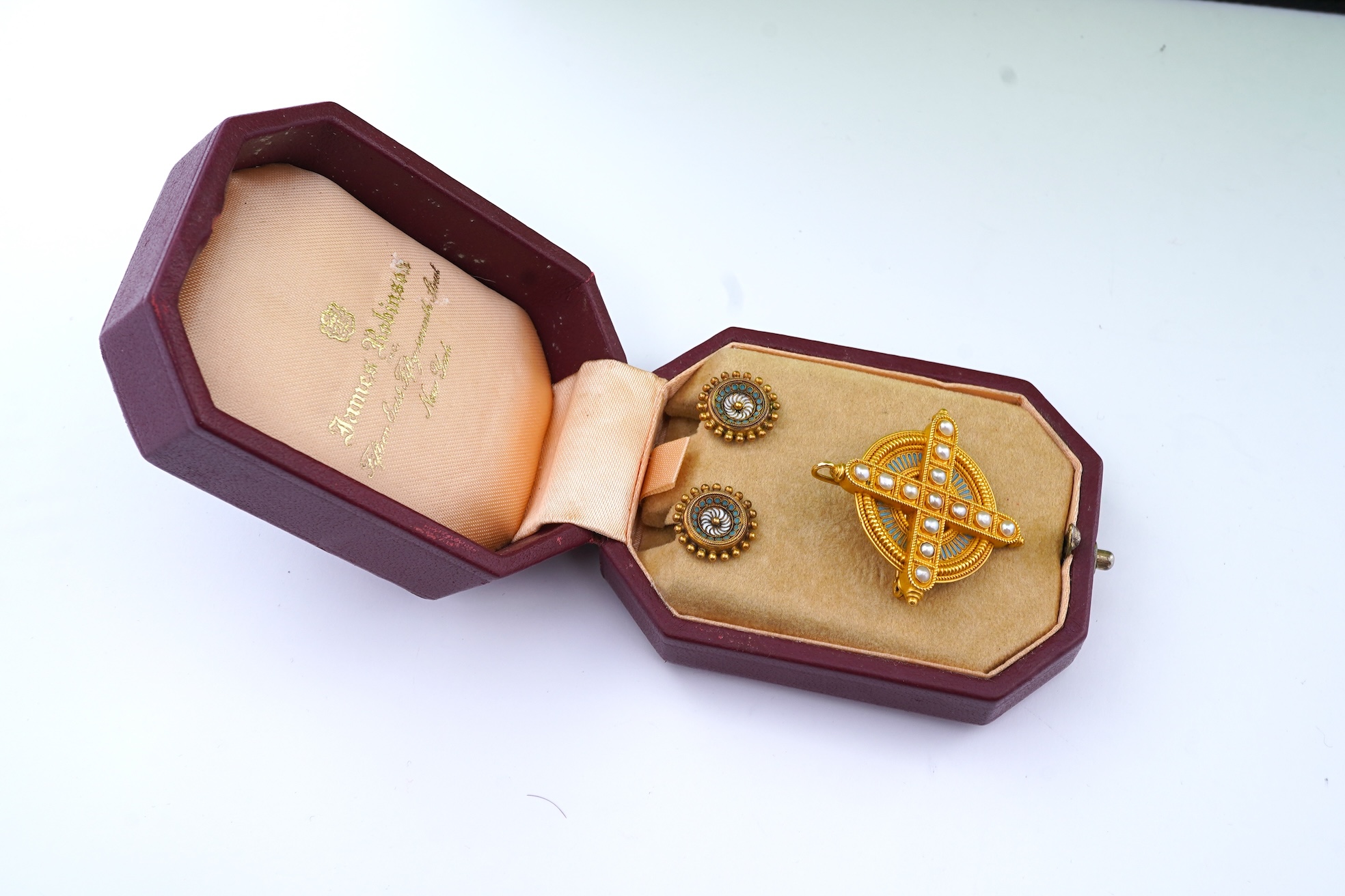 A gold, enamel and pearl pendant/brooch, mid 19th century, and a pair of earrings